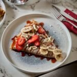 Madame Monsieur sweet crepe with strawberries, bananas, and white chocolate served with espresso in Budapest
